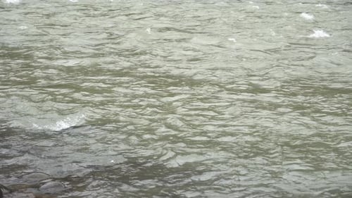 A mountain river with a strong flow of water flows into the gorges after a flood. Flood and water