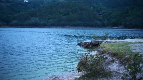landscape of lakeside with water and waves hitting shore