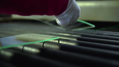 Low Angle View Of Panes Of Small Glass On Rolling Being Inspected By Worker. Close Up