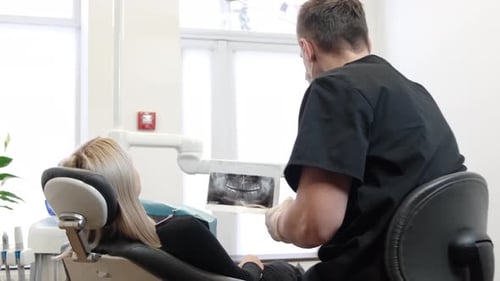Dentist Preparing for Procedure for Patient in Medical Clinic