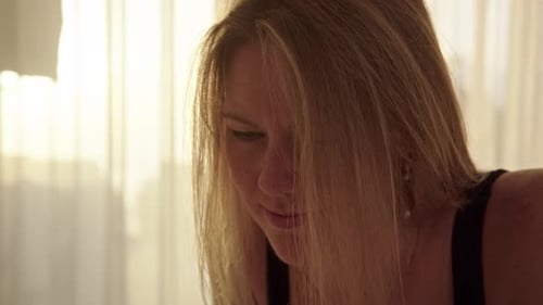 Close Up Young Woman Lies on Bed and Use Her Cell Phone