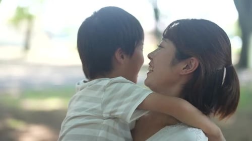 Loving Mother Embracing Child in Green Park