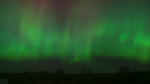 Intense green auroras take over as an intense solar storm impacts the area.