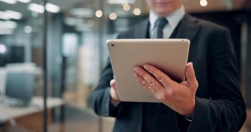 Hands, tablet and business man in office with typing in corridor, scroll