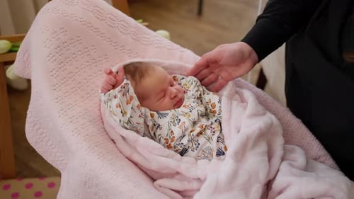 A Loving Mother Strokes and Rocks Her Baby