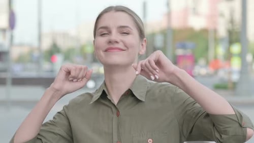 Cheerful Woman Smiling and Dancing in City