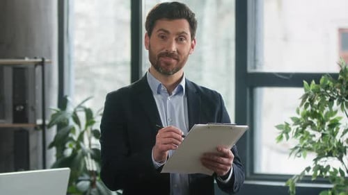 Business Man Taking Notes and Smiling