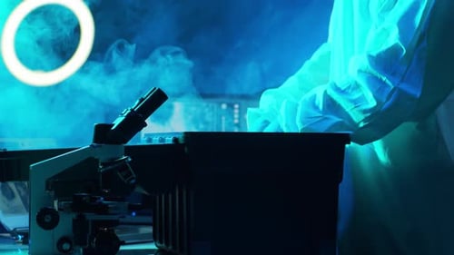 Scientist in Protection Suits and Masks Working in Research Lab Using Laboratory Equipment