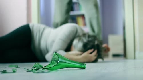 Terrified woman victim of domestic violence and abuse at home with cruel husband