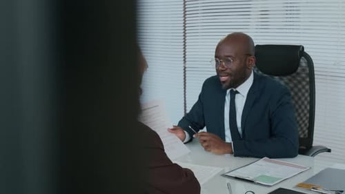 Business Professionals Discussing Documents at Modern Office