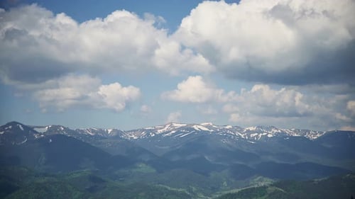 Lush Mountain Landscape with White Clouds