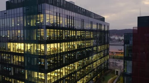 Aerial View of the Glass Facade of a Skyscraper at Night