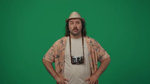 Man in Hat with Camera on Green Screen
