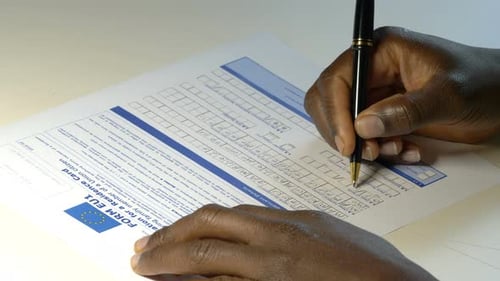 Immigration, legal. Young black man filling migration document