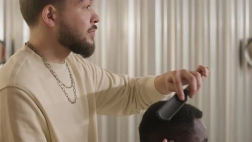 Barber Combing Hair in Bright Barbershop