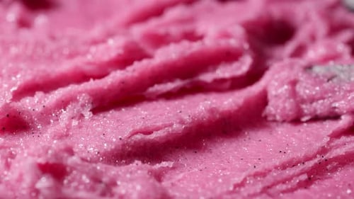 Texture of pink strawberry scrub. Fruit exfoliation scrubber for body and face in SPA.
