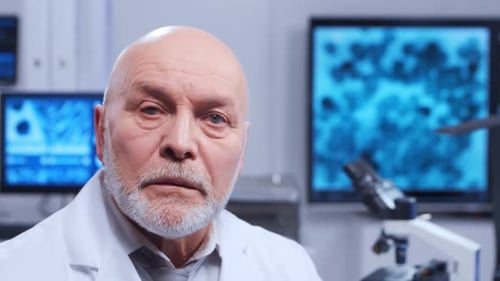 Mature Scientist Stares Intently in Modern Laboratory Setting