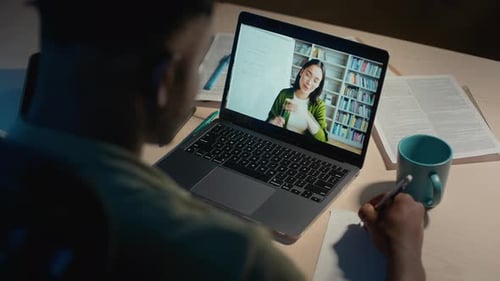 Student Taking Notes During Online Class