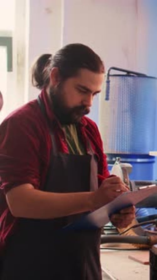 Vertical Video Craftsperson Drawing Blueprints in Studio Next to Coworker