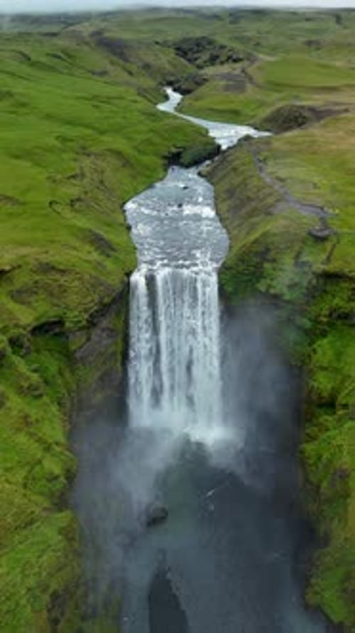 Skogafoss Waterfall Cascading Through Lush Green Landscape in Iceland