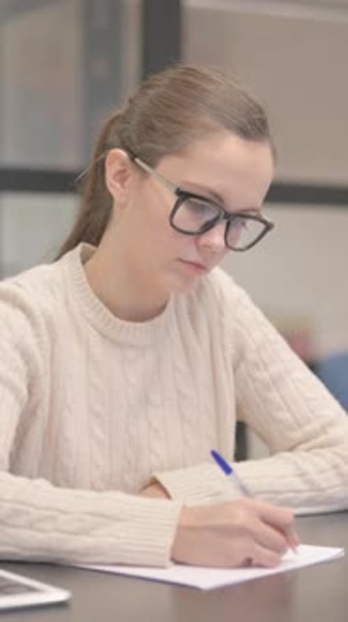 Young Woman Writing a Letter in Office