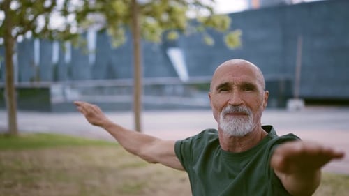 Mature Adult Stretching in Urban Park