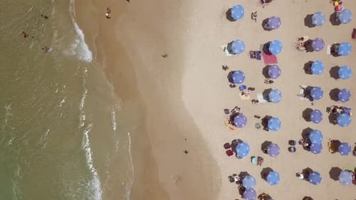 Summertime in a public Beach with colorful umbrellas