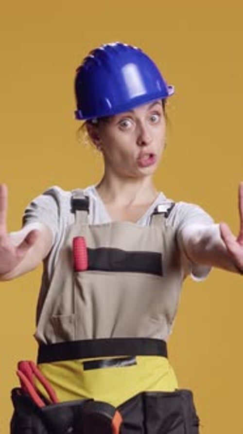 Vertical Video Portrait of Construction Worker Doing Stop Sign with Palm