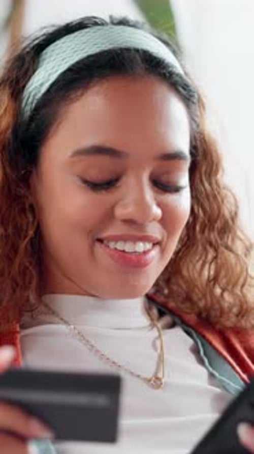 Young Woman Makes Mobile Payment With Credit Card