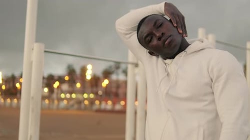 Side view of athlete does neck exercises outdoors