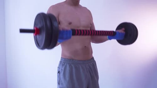 Man Performing Bicep Curls with Barbell Indoors