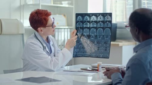 Female Doctor Explaining MRI Scan to Patient in Clinic