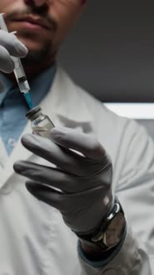Medical Professional Draws Medicine into Syringe