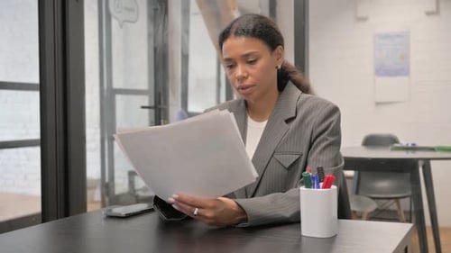 Woman Celebrates Success in Bright Office Workplace