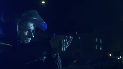 Officer Aims Gun in Dark Urban Environment