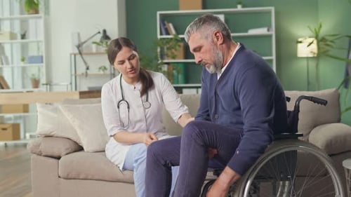 Medical Professional Helping Man in Wheelchair