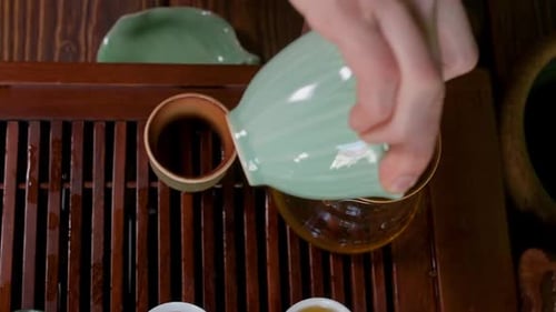 Tea being poured into glass container