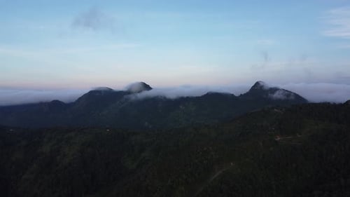 Aerial view of sea of fog on tropical mountains in the early morning. Layers of mountains