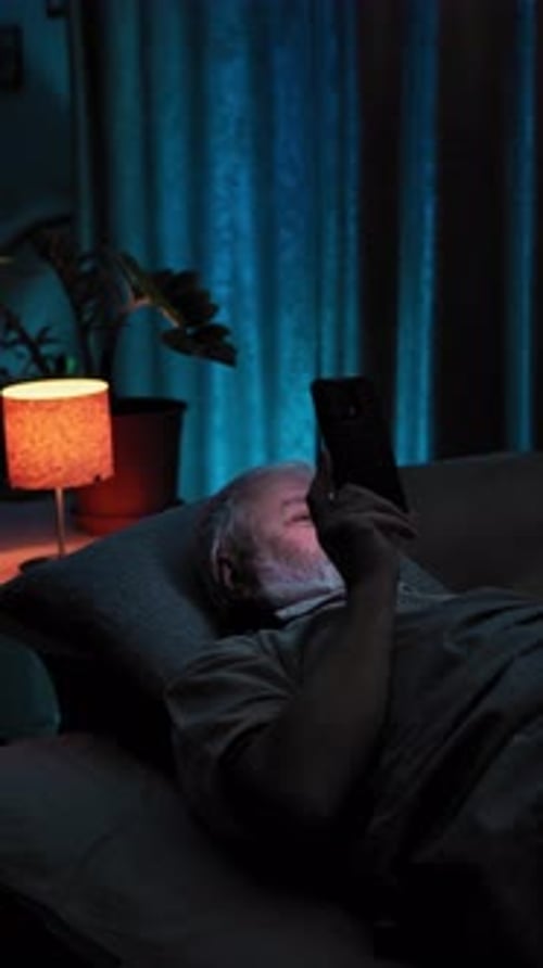 Pension Man in Bed Take Off Glasses Stop Watches the Content on His Phone