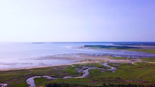 Sunken Meadows on Cape Cod, MA. The marsh and channels of water connect to the bay. The tide is low