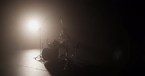 Male Musician Playing Drums on Stage During Rehearsal
