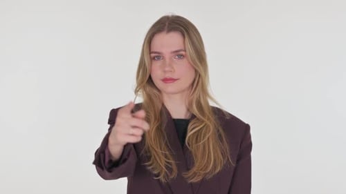 Young Woman Pointing at Camera in Studio