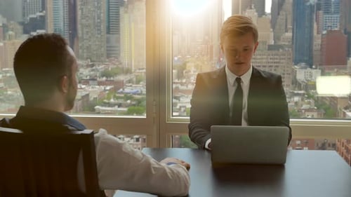 Two Men Talking in a High Rise Office