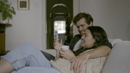 Loving Couple Relaxing on Sofa at Home
