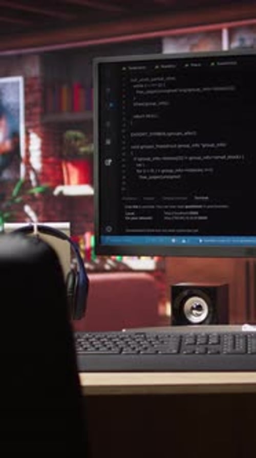 Vertical Video Development Console Visible on Computer Screen in Modern Apartment