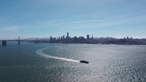 Large boat in the San Francisco Bay with San Francisco and Oakland Bridge