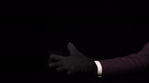 Smoke Emanates from Hand in Glove with Suit