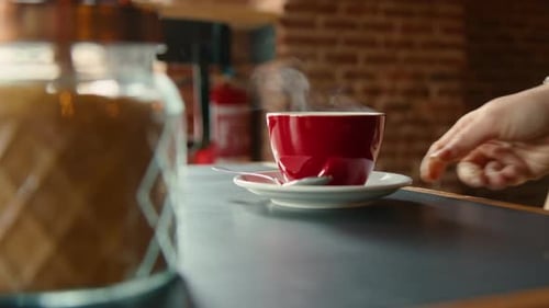 Close Up of Coffee Cup Being Placed on Counter