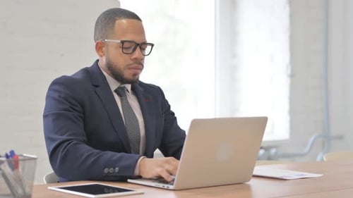 Man Working at Laptop in Office, Coughing