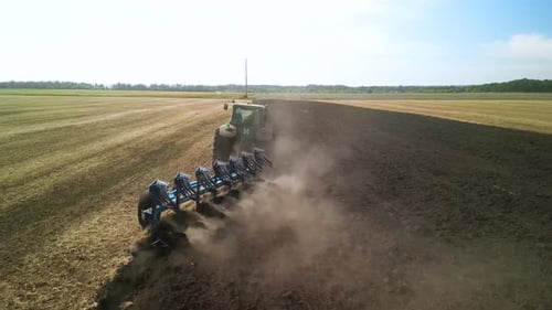 Tractors plowing the field in Ukraine